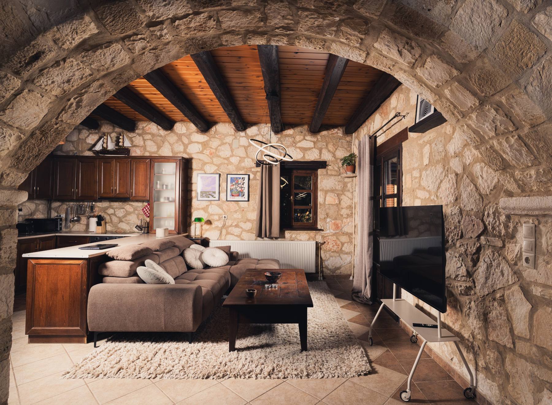 Living room with a sectional sofa opening to the kitchen