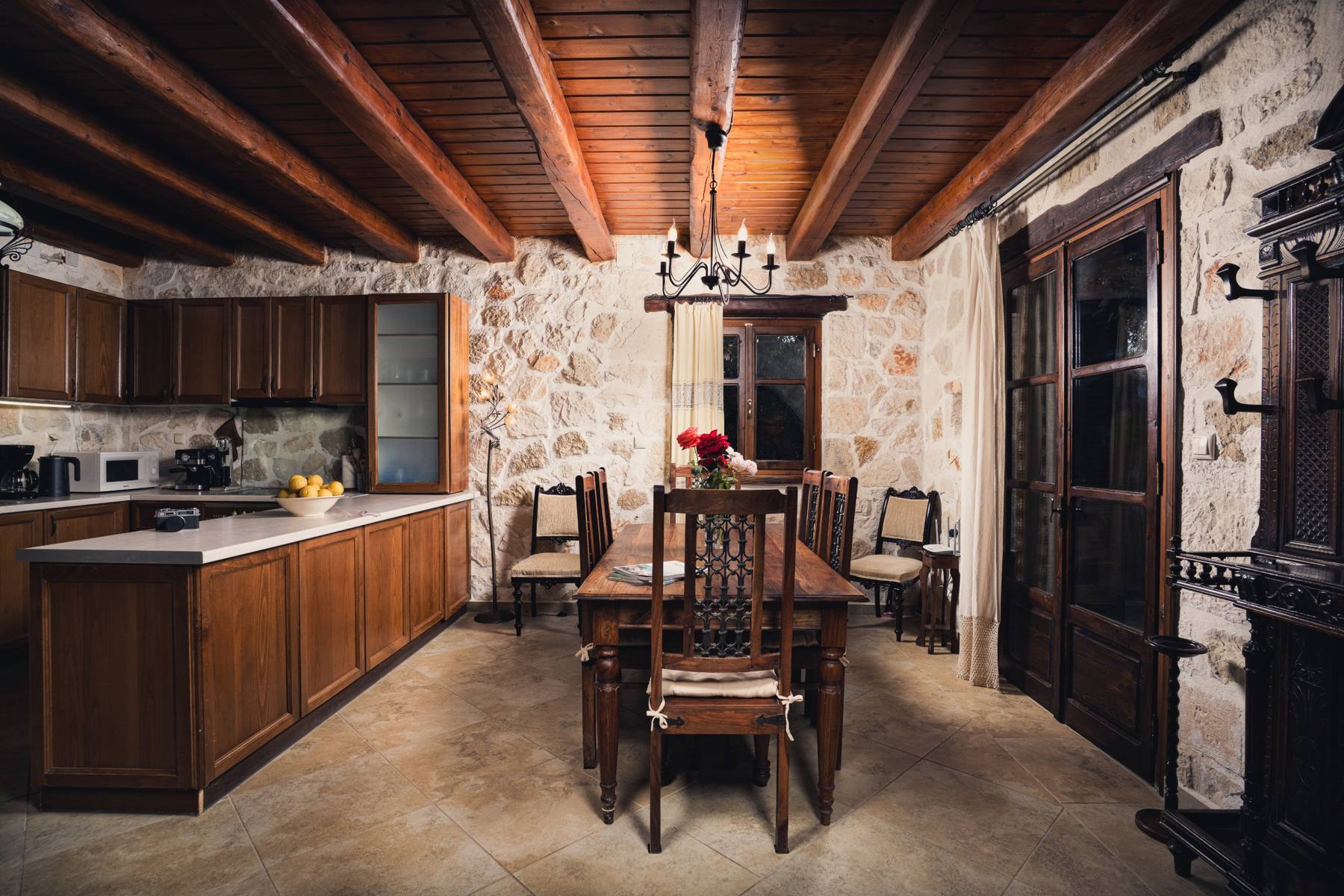 Dining table set with fresh lemons, kitchen behind