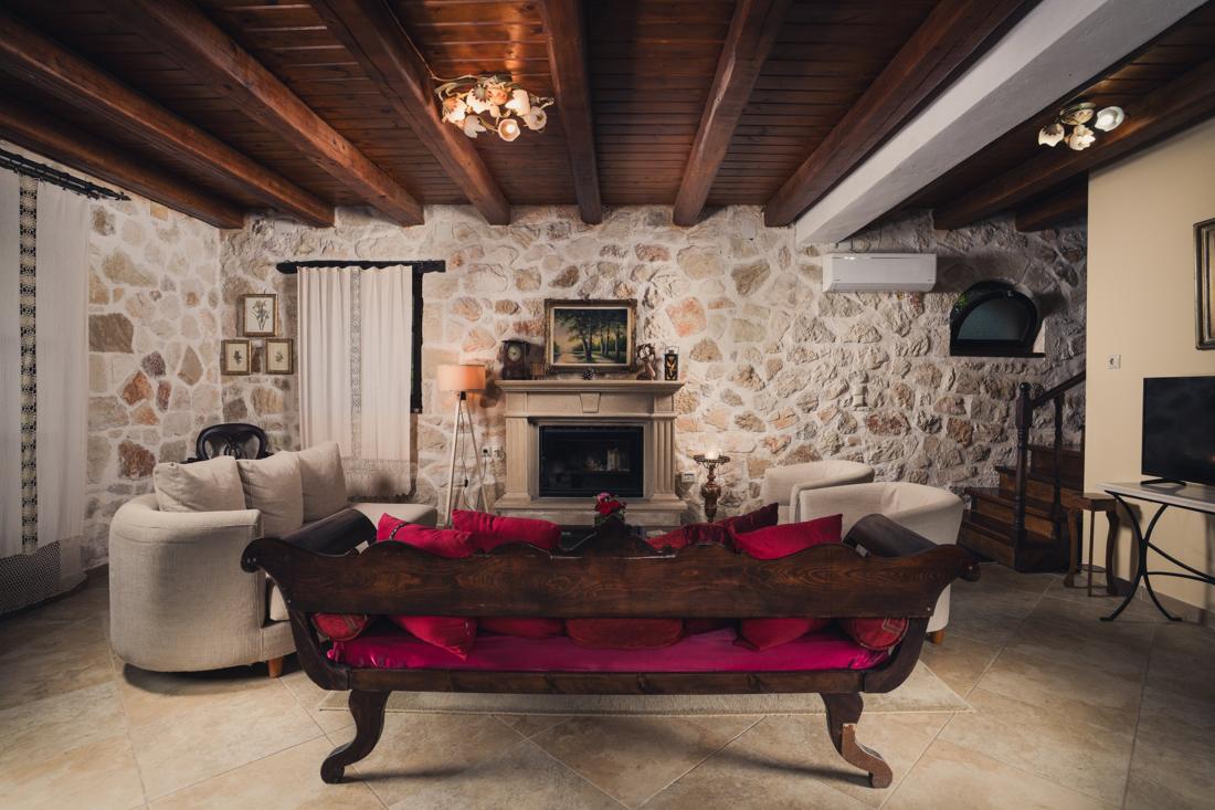 Living room with a fireplace and a carved daybed