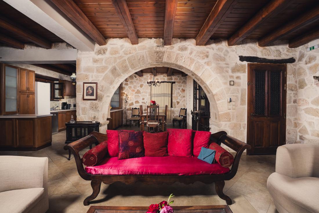Living room with cream sofas and a stone archway