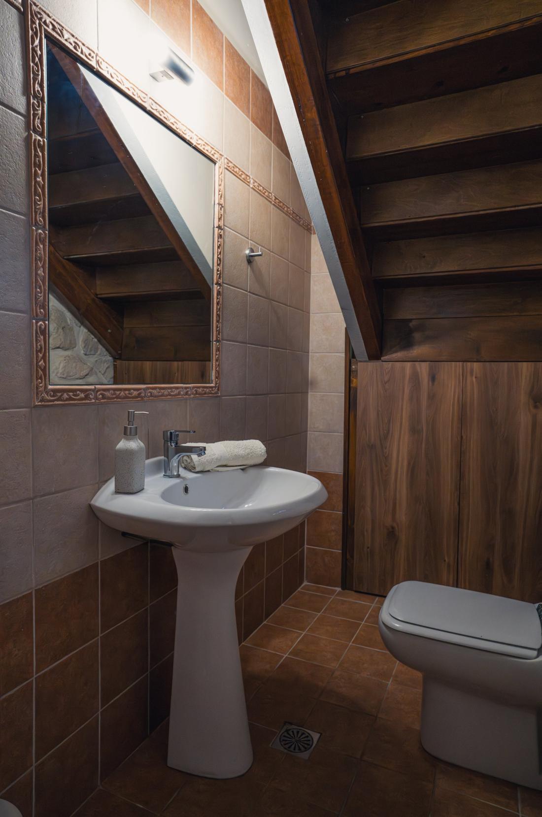 Bathroom with a pedestal sink and toilet