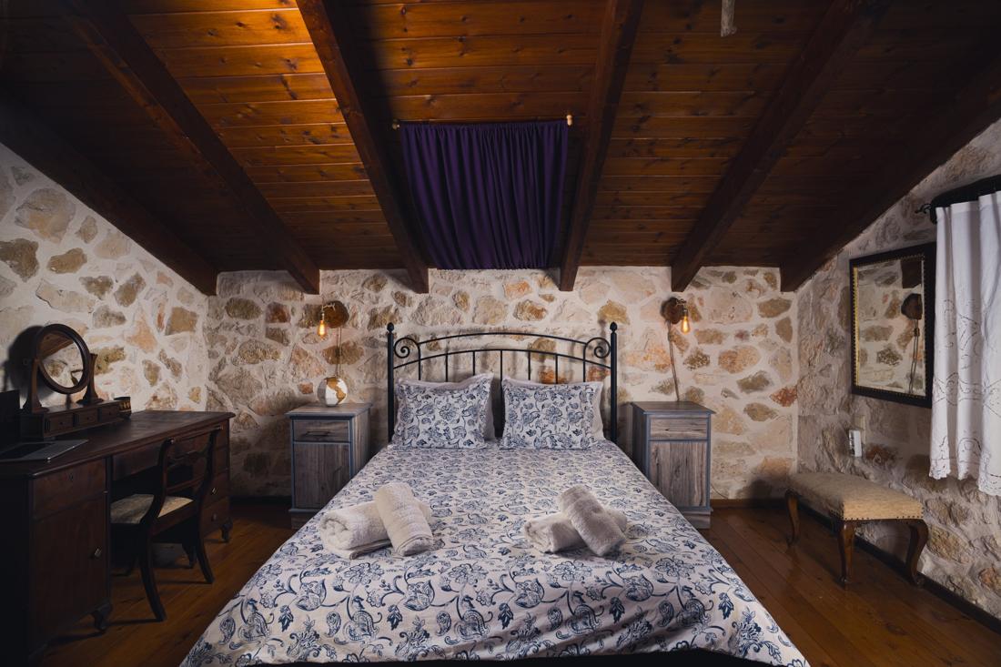 Bedroom with blue floral bedding, desk and mirror