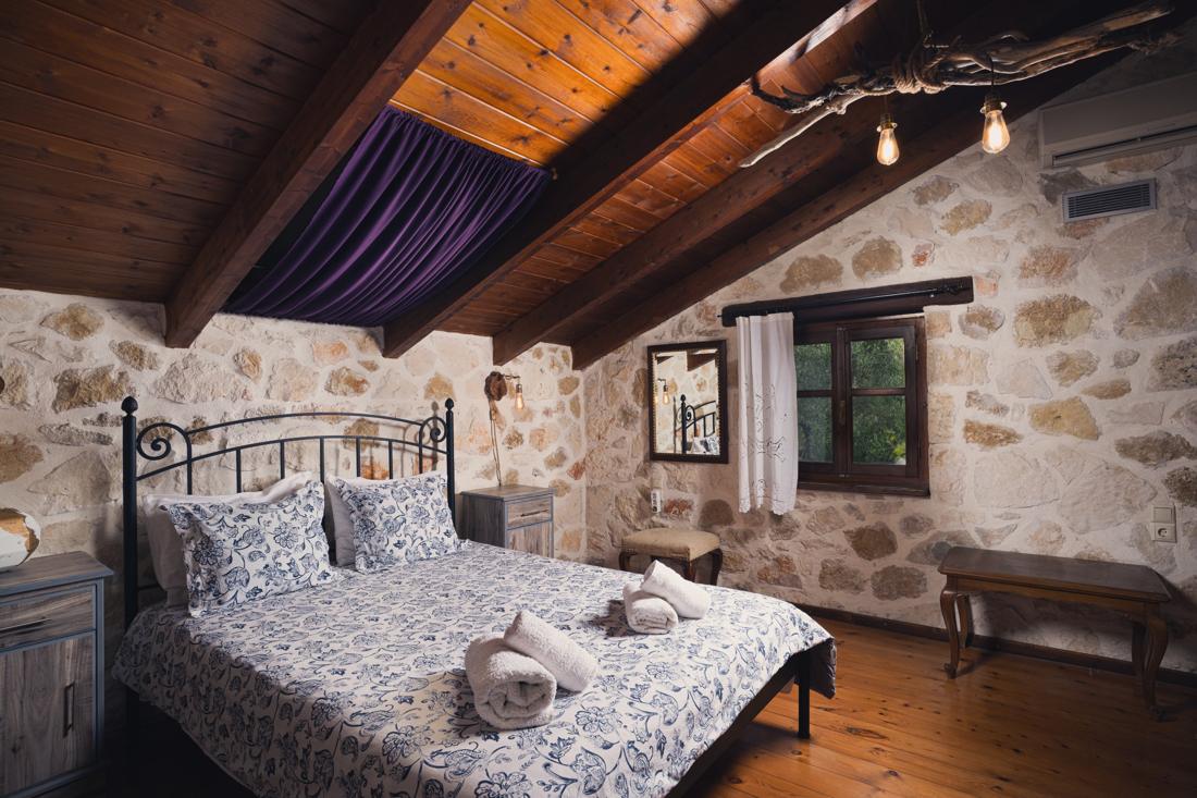 Bedroom with blue floral bedding by the window