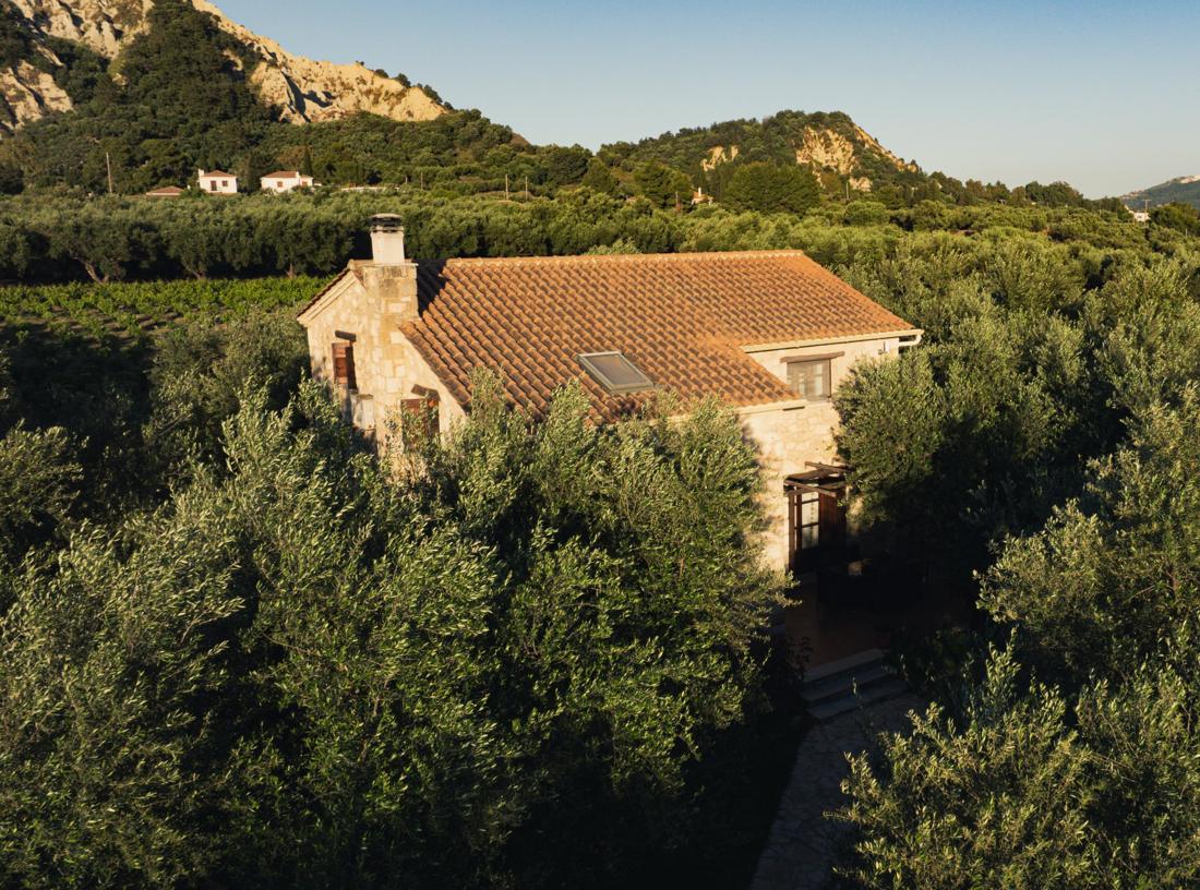 Stone villa with the hills behind it