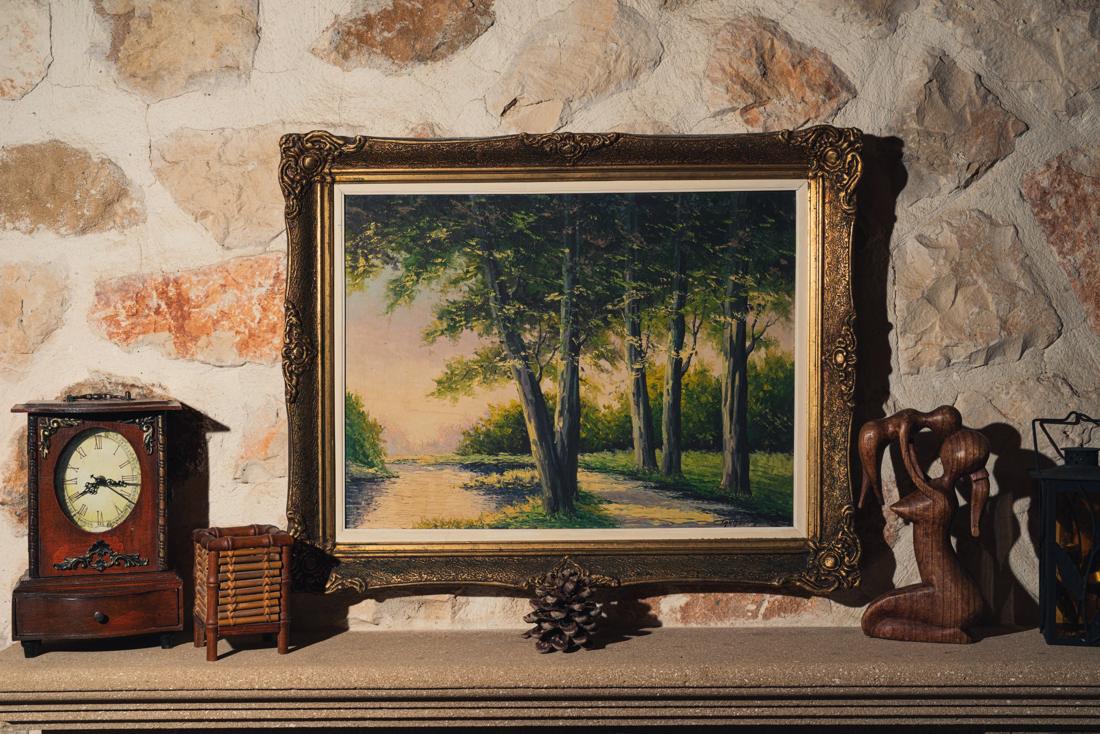 Mantel with a clock and a framed painting