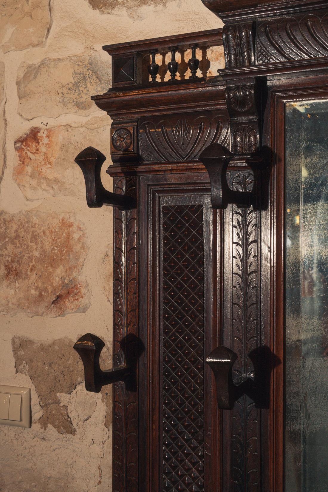 Carved wooden door and coat hooks