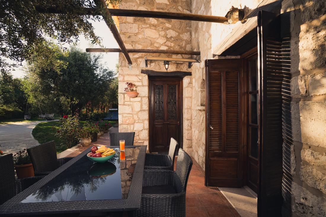 Terrace dining table with olive trees behind