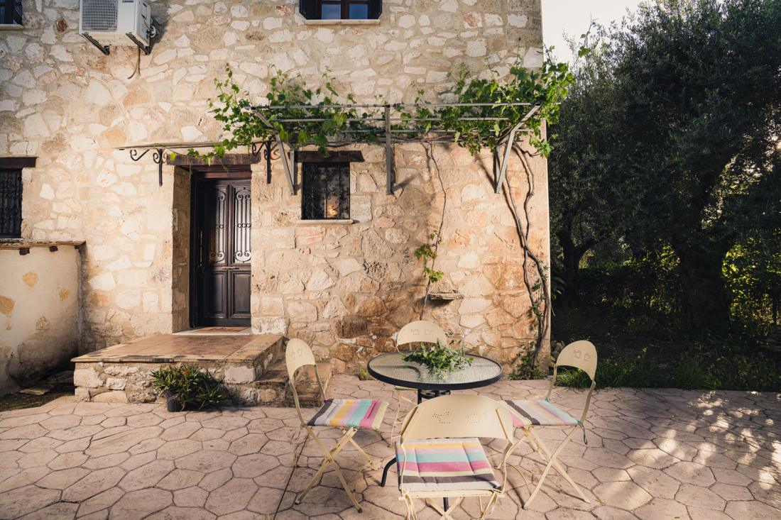 Stone courtyard with a small table and chairs